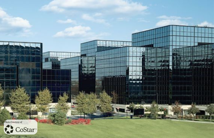 Modern glass facade of 100 First Stamford Place commercial property in Stamford, Connecticut.