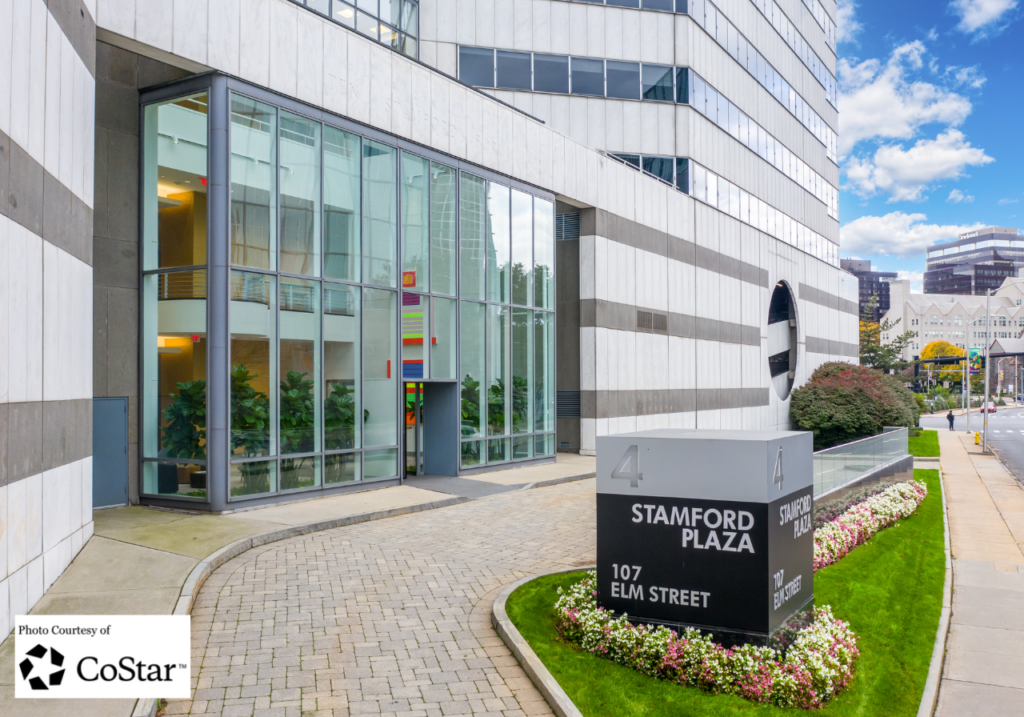 The sleek high-rise front entrance facade of 107 Elm Street Stamford within the Stamford Plaza complex.