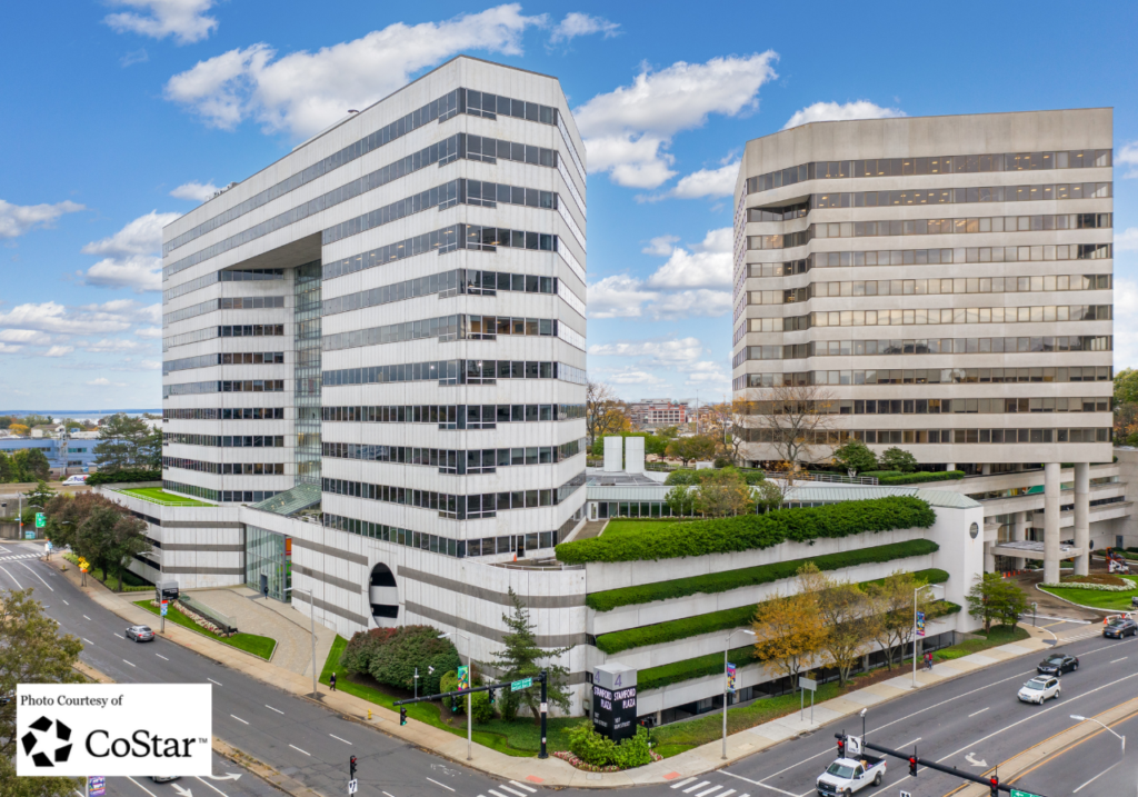 The sleek high-rise exterior facade of 107 Elm Street Stamford within the Stamford Plaza complex.